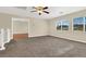 Open bonus room with neutral carpeting, ceiling fan and view to the mountains at 1307 Summer Dawn Ave, Henderson, NV 89014