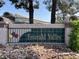 An Emerald Valley community sign sits on a small rock covered hill, welcoming residents and visitors alike at 1307 Summer Dawn Ave, Henderson, NV 89014