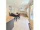Bright dining area featuring a granite-topped kitchen island and views into the spacious adjacent living room at 1307 Summer Dawn Ave, Henderson, NV 89014
