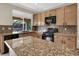 Well-appointed kitchen features light wood cabinets, granite countertops, and stainless steel appliances at 1307 Summer Dawn Ave, Henderson, NV 89014