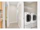 Convenient laundry area equipped with a modern washer and dryer, neatly organized with overhead shelving at 1307 Summer Dawn Ave, Henderson, NV 89014