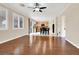 Open-concept living room flows into the kitchen and features hardwood floors, neutral paint, and lots of sunlight at 1307 Summer Dawn Ave, Henderson, NV 89014