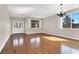 Bright living room with hardwood floors, plantation shutters, and double doors leading to another living space at 1307 Summer Dawn Ave, Henderson, NV 89014
