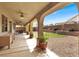 Relaxing outdoor patio with arched support beams, manicured turf, and thoughtfully arranged landscape elements at 1307 Summer Dawn Ave, Henderson, NV 89014