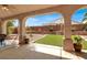 Inviting outdoor patio with manicured turf, lush plants, and a well-designed landscape at 1307 Summer Dawn Ave, Henderson, NV 89014