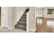 Elegant staircase leading to the upper level, featuring a carpeted runner and abundant natural light at 1307 Summer Dawn Ave, Henderson, NV 89014
