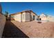 A backyard features a patio area with desert landscaping, a grill, and lawn area at 1636 Royal Palm Dr, Las Vegas, NV 89128