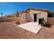 A backyard features a patio area with desert landscaping, a grill, and a fire pit at 1636 Royal Palm Dr, Las Vegas, NV 89128