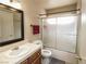 A bathroom featuring a vanity with a sink, mirror, and a shower-tub combo with sliding doors at 1636 Royal Palm Dr, Las Vegas, NV 89128