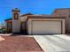 Charming single-story home featuring a two-car garage, desert landscaping, and a tiled roof at 1636 Royal Palm Dr, Las Vegas, NV 89128