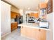 Well-lit kitchen featuring stainless steel appliances, wooden cabinetry, and tiled countertops at 1636 Royal Palm Dr, Las Vegas, NV 89128