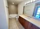 Bathroom features a wooden vanity, ceramic tile flooring, and tub shower combo at 200 W Sahara Ave # 3909, Las Vegas, NV 89102