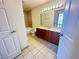 Bathroom features a wooden vanity, ceramic tile flooring, and tub shower combo at 200 W Sahara Ave # 3909, Las Vegas, NV 89102