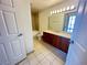 Bathroom features a wooden vanity, ceramic tile flooring, and tub shower combo at 200 W Sahara Ave # 3909, Las Vegas, NV 89102