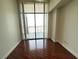 Bedroom features floor to ceiling windows with city views and wood flooring at 200 W Sahara Ave # 3909, Las Vegas, NV 89102