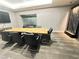 Modern conference room with a large wood table, black chairs, and a decorative water feature at 200 W Sahara Ave # 3909, Las Vegas, NV 89102