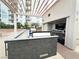 This outdoor kitchen features a stainless grill, countertop, sink, and mounted television at 200 W Sahara Ave # 3909, Las Vegas, NV 89102