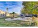 Backyard seating area with a fire pit, shed, and partial view of the main house at 2125 Mateuse St, Logandale, NV 89021