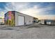 Exterior of a spacious barn with a mural, multiple bays, and ample parking space at 2125 Mateuse St, Logandale, NV 89021