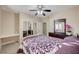 Bedroom with a ceiling fan, mirrored closet doors and a vanity with built in desk at 2125 Mateuse St, Logandale, NV 89021