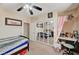 Bedroom with neutral carpet, ceiling fan, mirrored closet doors, and a built-in desk at 2125 Mateuse St, Logandale, NV 89021