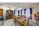 Elegant dining room with contemporary chandelier, window shutters and wood furniture at 2125 Mateuse St, Logandale, NV 89021