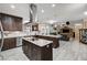 Gourmet kitchen open to the living room with a center island, stainless appliances and wood cabinetry at 2125 Mateuse St, Logandale, NV 89021