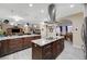 Spacious kitchen features gray tile floor and oversized island with granite countertops at 2125 Mateuse St, Logandale, NV 89021