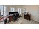 Spacious office featuring carpeted floors, a large desk setup, and natural light from multiple shuttered windows at 2125 Mateuse St, Logandale, NV 89021