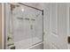 The shower features a glass door, marble tile, and wall niche at 2125 Mateuse St, Logandale, NV 89021