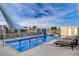 Private outdoor swimming pool with a sunshade and lounge chairs for relaxation at 2125 Mateuse St, Logandale, NV 89021