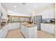 Well-appointed kitchen with white cabinets, island, stainless appliances, and tile flooring at 2320 Anderson Park Dr, Henderson, NV 89044
