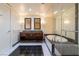 This bathroom features a glass enclosed shower, soaking tub, double vanity and stone tile at 2700 Las Vegas Blvd # 4101, Las Vegas, NV 89109