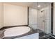 A large soaking tub and glass enclosed shower can be found in this bathroom at 2700 Las Vegas Blvd # 4101, Las Vegas, NV 89109