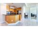 Well-lit kitchen boasting modern wood cabinets, stainless appliances, a breakfast bar, and marble floors at 2700 Las Vegas Blvd # 4101, Las Vegas, NV 89109