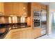 Detailed view of the kitchen with stainless steel appliances, granite countertops, and warm wood cabinetry at 2700 Las Vegas Blvd # 4101, Las Vegas, NV 89109