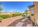 Low maintenance backyard with desert landscaping and a covered patio at 2776 White Sage Dr, Henderson, NV 89052