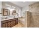 Bright bathroom featuring a double vanity, soaking tub, and luxurious tiled shower at 2776 White Sage Dr, Henderson, NV 89052