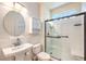 Bright bathroom featuring a glass-enclosed shower, a modern sink, and neutral tones at 2776 White Sage Dr, Henderson, NV 89052