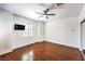 Bright bedroom with wood floors, large window and mirrored sliding door closet at 2776 White Sage Dr, Henderson, NV 89052