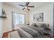 Comfortable bedroom with modern decor, large window, and a ceiling fan at 2776 White Sage Dr, Henderson, NV 89052