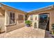 Inviting front entryway with decorative brick pavers, mature landscaping, and an ornate security door at 2776 White Sage Dr, Henderson, NV 89052