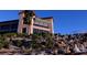 Beautiful exterior shot of the building showing the rock and desert landscaping at 2776 White Sage Dr, Henderson, NV 89052