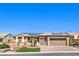 Inviting single-story home featuring lush landscaping, pavers driveway and solar panels at 2776 White Sage Dr, Henderson, NV 89052