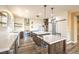 Modern kitchen features sleek countertops, island, pantry with sliding door, and wooden accents at 2776 White Sage Dr, Henderson, NV 89052