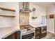 Gourmet kitchen with gas range, decorative backsplash, and custom wood cabinetry at 2776 White Sage Dr, Henderson, NV 89052