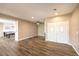 Open-concept living room with luxury vinyl flooring and a view into the dining area and kitchen at 2776 White Sage Dr, Henderson, NV 89052