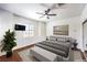 Serene main bedroom featuring modern decor, a ceiling fan, and a large window at 2776 White Sage Dr, Henderson, NV 89052