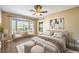 Bright main bedroom with a bay window, neutral decor, and a ceiling fan at 2776 White Sage Dr, Henderson, NV 89052