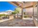 Outdoor kitchen with built-in grill, rock detail, tile flooring, and covered patio at 2776 White Sage Dr, Henderson, NV 89052